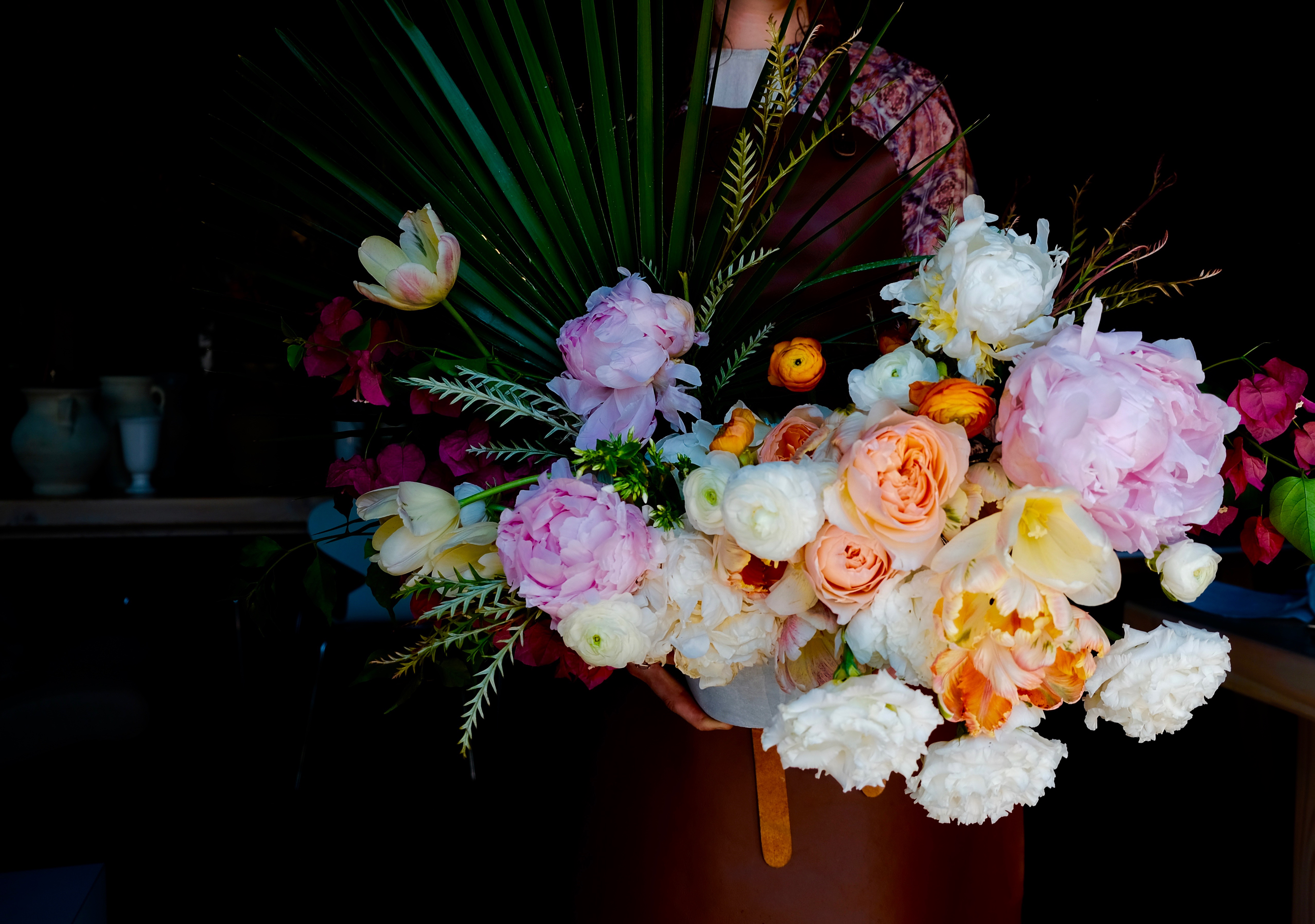 Floral arrangement with palm leaves